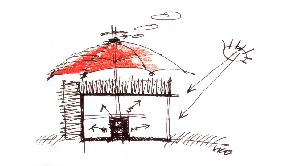 Dům v kožichu. Vnější strana jeho stěn je pokrytá slámou, střechu domu tvoří velký igelitový deštník